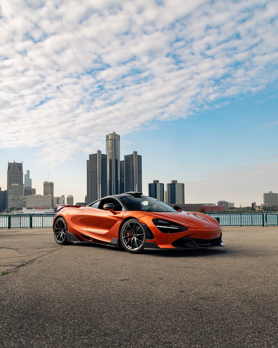 Orange McLaren on display at Cars for a Cause with the Detroit skyline behind it